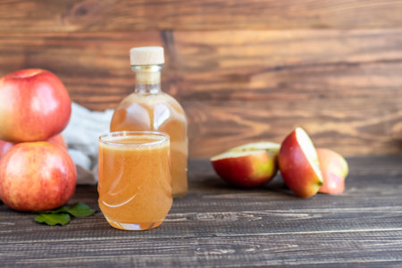 Freshly squeezed apple juice on a dark background. Useful vitamin, antiviral drink. Copy space
