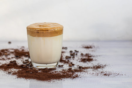 Dalgona coffee is a trendy cold Korean drink. Tasty, aromatic coffee with milk and sugar in a glass...