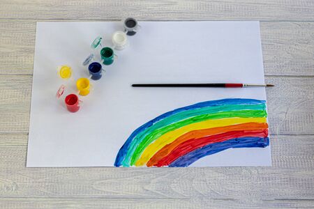 Handmade crafts. Creative activities for children on vacation and in quarantine. Rainbow painted by a girl. Mask for protection against the virus. Children's creativity. Copy space.の写真素材