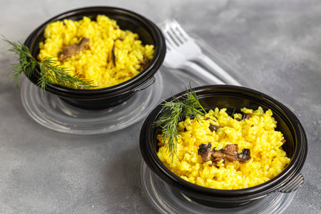 Italian risotto with champignons and parmesan. Food is delivered to your home in quarantine in...