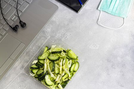 Coronavirus. Quarantine Online training, education and freelance work. Lunch delivery. Laptop, phone and medical mask for protection. Coronavirus pandemic in the world. Closing offices.の写真素材