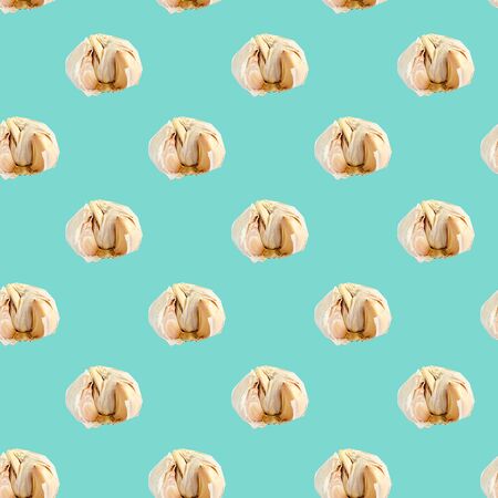 Seamless pattern with garlic on a blue background. Minimal isometric texture of food. Use for boards, print on fabric. View from above.の写真素材