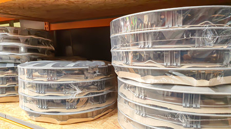 Car rims on store shelves. Waiting for a buyer. On wooden coasters. Various alloy wheels.