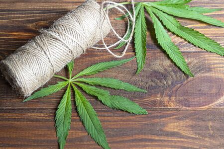 Cannabis fabric and rope on wooden background. Industrial production. Copy spaceの写真素材