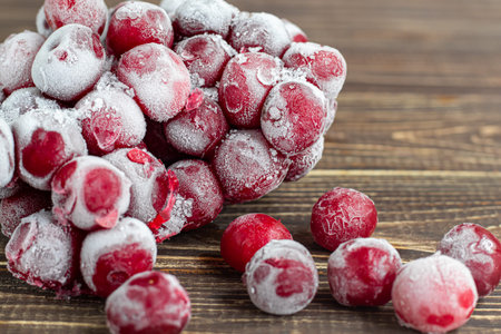 Frozen fruits. Frozen fruit mixture of currants, cherries and strawberries. Vitamin Blend. On a dark...