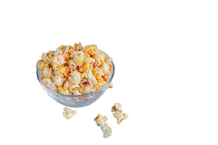 A transparent bowl of popcorn on a light surface. Copy space.の写真素材