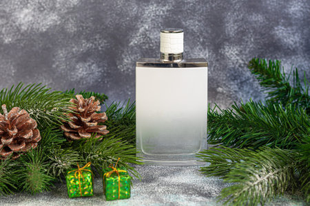 Perfume bottle. Surrounded by Christmas tree branches and Christmas toys. Gift concept for New Year...