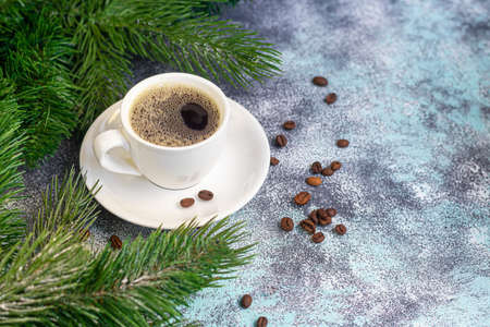 A cup of delicious aromatic coffee. It is placed on a substrate made of coffee beans. New Year holiday concept. On a light background. Copy space.の写真素材