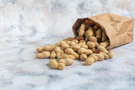 Peanuts. Contains beneficial vitamins and minerals. On a gray background. Copy space.の写真素材