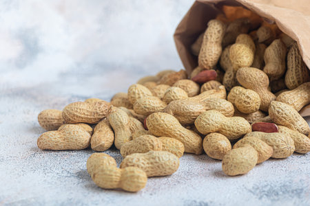 Peanuts. Contains beneficial vitamins and minerals. On a gray background. Copy space.