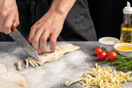 Step by step instructions for making homemade noodles. The cook is cutting the dough. Wooden...
