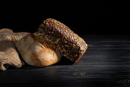 Homebaked bread. Cereal powder, gluten free. Dark background. Copy space.の写真素材