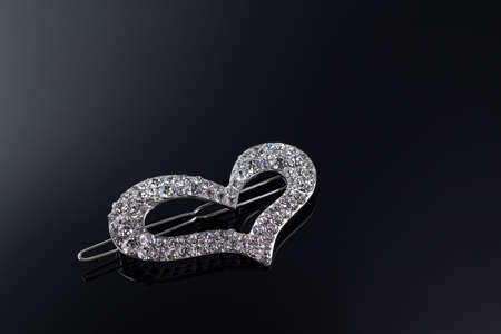 Bijouterie and jewelry on a dark background. Brooches and hairpins earrings and pendants. Copy spaceの写真素材