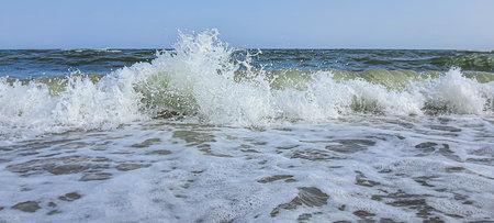 Seascape. Azure color of water, waves foaming on the shore. Selective focus. Summer rest.