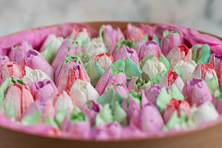 Handmade marshmallows in wooden packages on a light background with flowers. The concept of the...