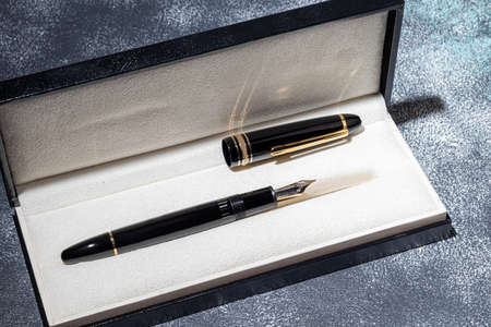 Fountain pen on a marble and gray background. selective focus. copyspace.の写真素材