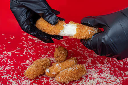 Cheese in batter with cherry sauce in a paper plate. fast food. colored background. copy spaceの写真素材