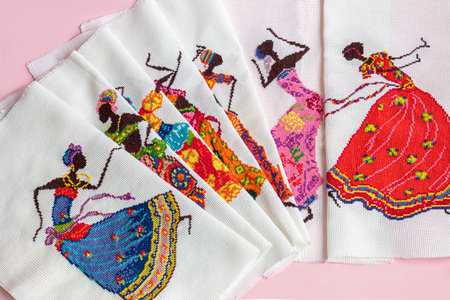 handmade embroidery. Multicolored patterns on white fabric. Ethnic drawing. copyspace.