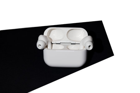 White wireless headphones in a box. Isolate. Accessory for listening to music.
