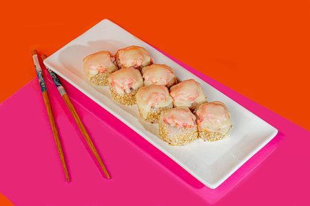 Sushi sets, rolls with caviar, shrimp, tuna and avocado and Philadelphia cheese, on a white plate.
