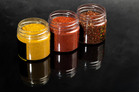 Variety of spices on a dark background in a glass bowl. Enhancement of taste. copy spaceの写真素材