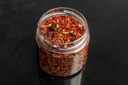 Variety of spices on a dark background in a glass bowl. Enhancement of taste. copy spaceの写真素材