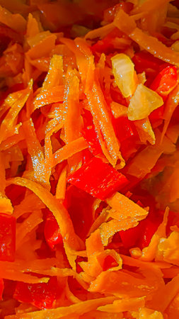 Vegetable stew. Carrots, onions and bell peppers in a frying pan. Vegetarian diet.Copy space.の写真素材