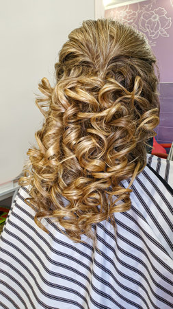 Hairstyle, curls and strands in a beauty salon. Long hair, beauty and health. selective focusの写真素材