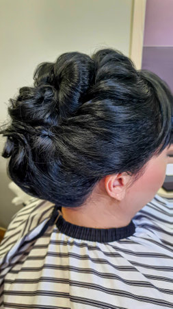 Wedding and holiday hairstyle. Braiding and hair styling in a beauty salon. Copy spaceの写真素材