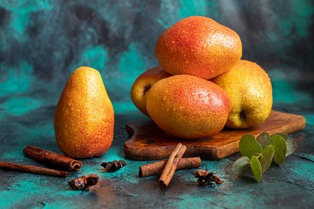 Pears on a dark background. Fresh, ripe fruits on a blue plate and in a box. Healthy eating. Copy space.の写真素材