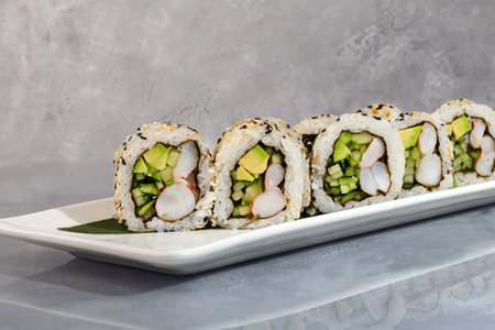 Sushi and rolls with caviar, shrimp and tuna, avocado on a gray background.の写真素材