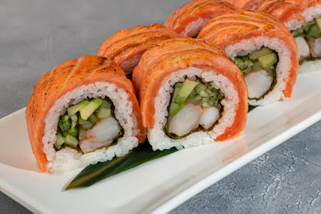 Sushi and rolls with caviar, shrimp and tuna, avocado on a gray background.の写真素材