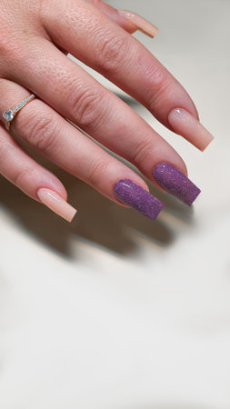 Manicure and nail extensions with acrylic and gel. The design is made with shiny gel polishes. Copy spaceの写真素材