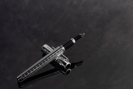 Fountain pen on marble and gray background with reflection. Vibration focus.の写真素材