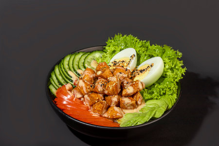 Salad bowl with chicken breast, rice, tomatoes, cucumbers and avocado. Boiled egg. Copy spaceの写真素材