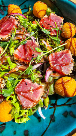Salad with tuna and cheese balls topped with soy sauce. Fast and healthy food. Copy spaceの写真素材