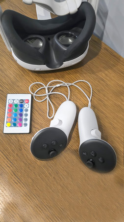 Virtual game set. VR headset. Glasses are on the table next to the control panel. Copy space
