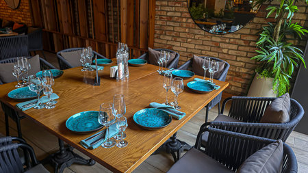 Interior in a city restaurant. Preparation for a buffet. Dishes and food