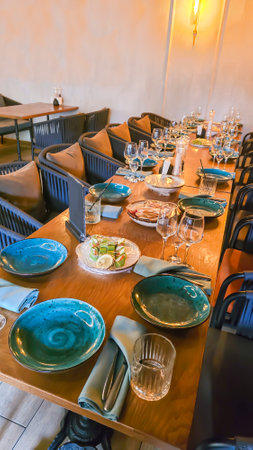 Interior in a city restaurant. Preparation for a buffet. Dishes and foodの写真素材