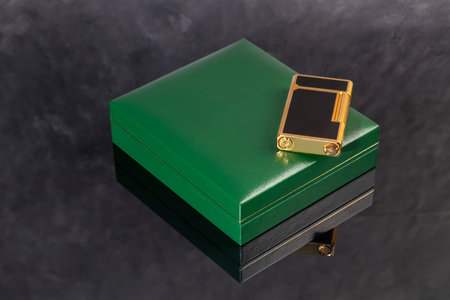 High quality lighter in a box on a dark background. Office interior. Copy space
