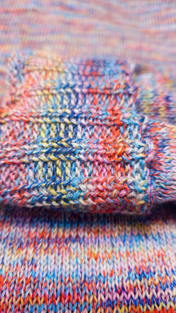 Knitted product from colored threads. Ready-made handmade women's sweater. Copy space