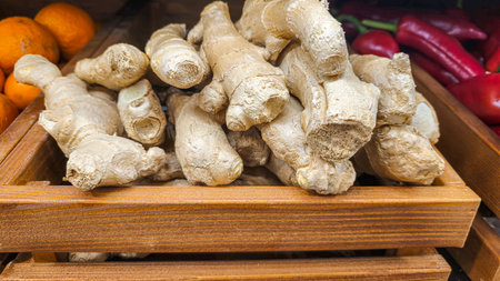 Ginger roots on the counter in the supermarket. Prepared for sale. Healthy food. Product display