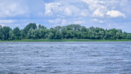 River surrounded by trees. Camping Volumetric clouds. Outdoor recreation.の写真素材