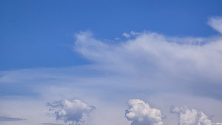 Blue sky with voluminous fluffy clouds.