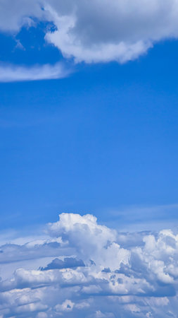 Blue sky with voluminous fluffy clouds.