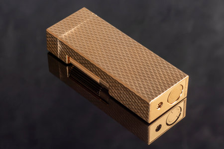 Branded gold lighter in a box. Rare item. Selective focus. Office interior.の写真素材