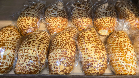 Bread and rolls on display at the store. Freshly baked goods for sale. Bread, kalachi, bagels, and...