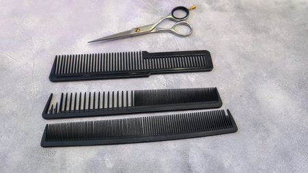 Special hairdressing scissors and comb. Professional equipment. On a gray background. Copy space