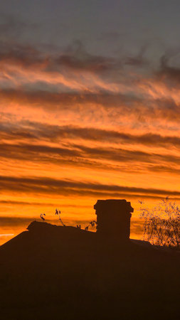 The red-crimson and orange evening sky over the city. Fiery sunset.の写真素材
