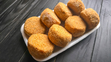 Freshly frozen breaded fish cakes. Round, semi-finished products, ready to cook. Seafood.